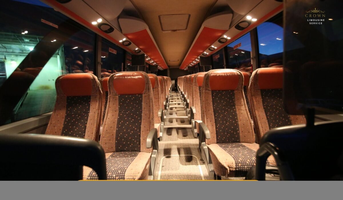 Interior shot of a vibrant party bus featuring colorful LED lighting, wrap-around leather seating, a built-in sound system, and a group of people dancing and enjoying the ride.