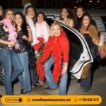 stretch limousine with a group of people standing besides