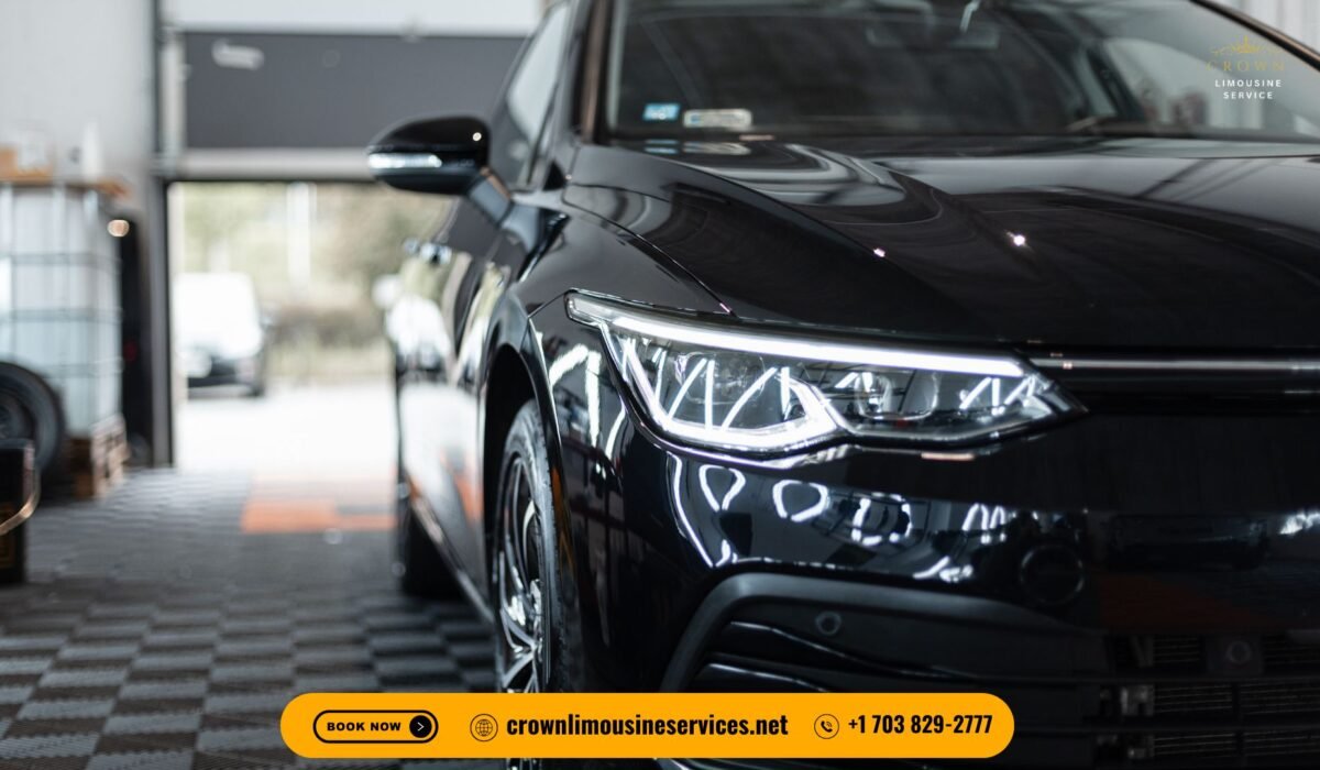 A sleek black luxury sedan parked in front of an upscale hotel